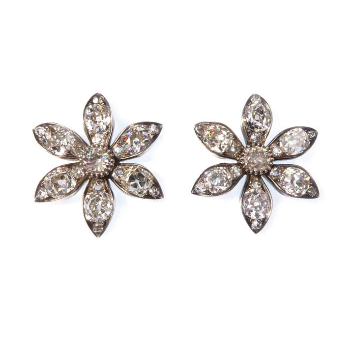 Pair of cushion cut diamond six petal flower brooches